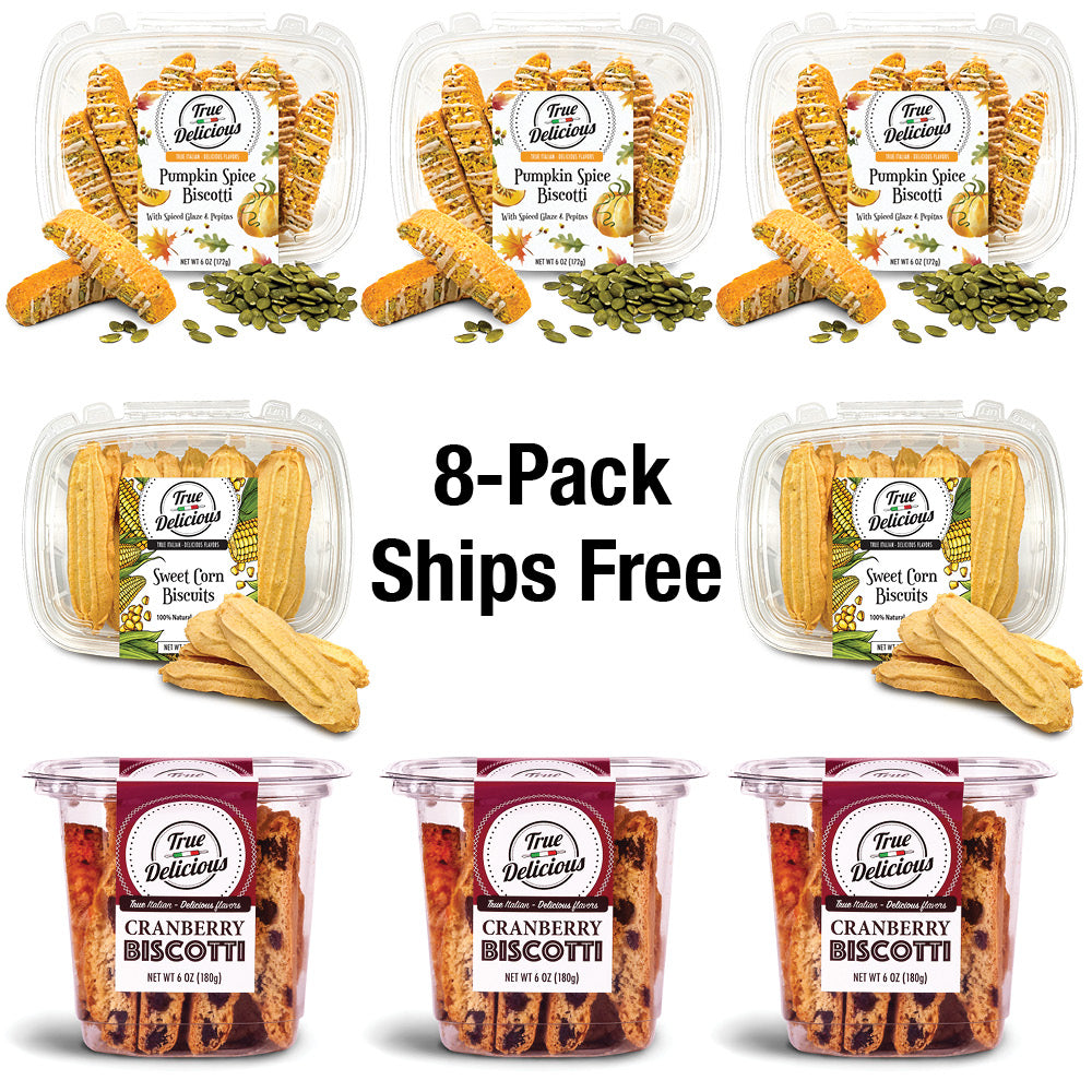 Eight True Delicious "Bundle of the Month" non-GMO cookies are arranged in two rows: pumpkin spice and sweet corn flavors on top, cranberry biscottis below. Center text reads: 8-Pack Ships Free.