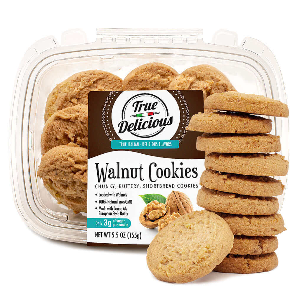 A clear plastic container labeled “True Delicious Biscotti Walnut Shortbread Cookies” sits behind a stack of golden brown cookies, with the label highlighting their nutty sweetness and featuring nutrition details.